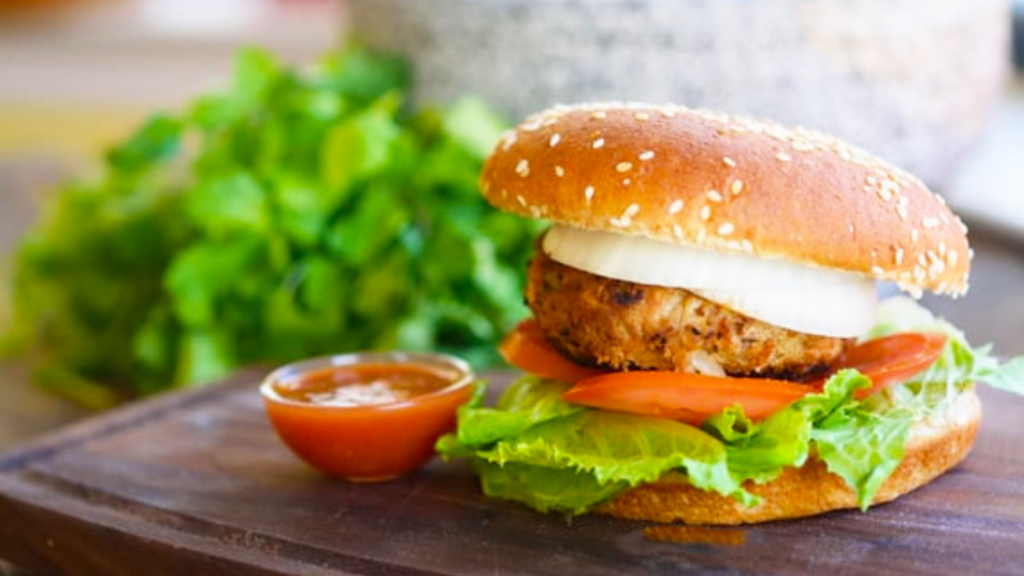 A single taco burger sitting on a cutting board.