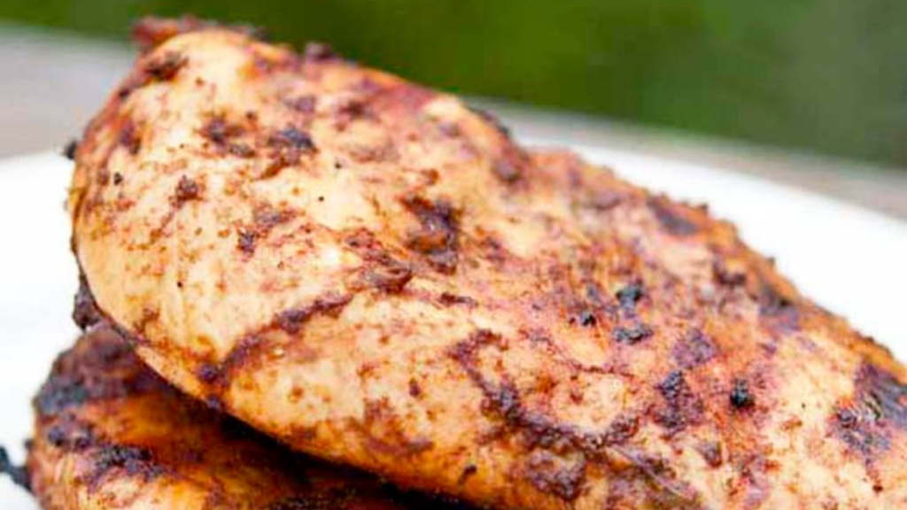 A close up of two tandoori chicken breasts.