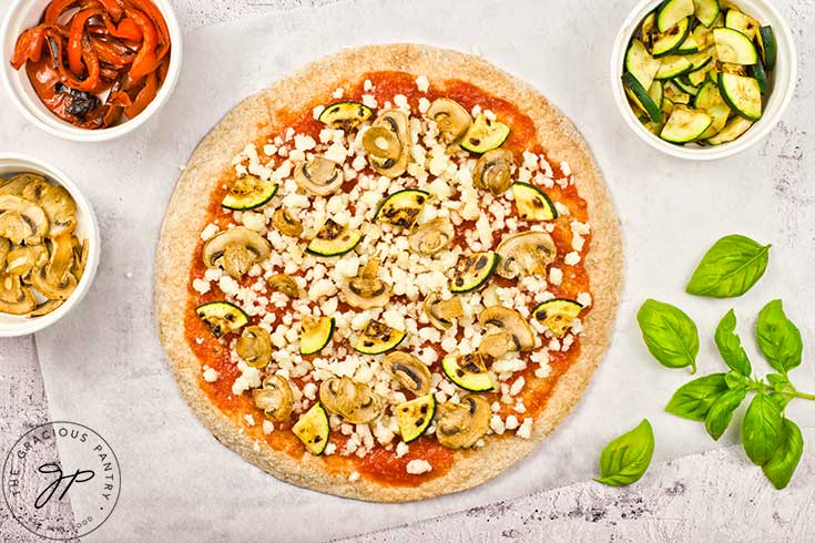 Cooked zucchini added to the veggie pizza.