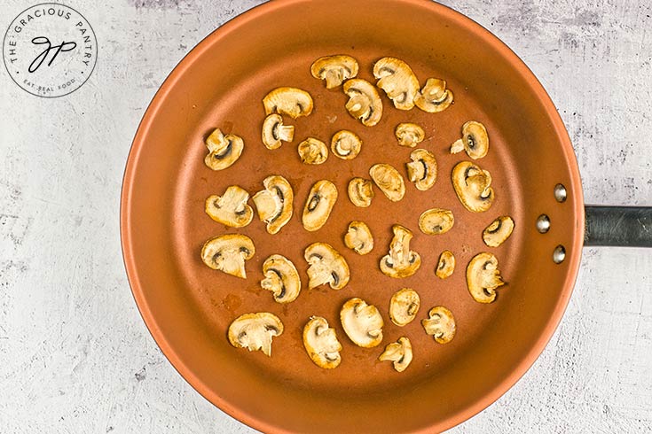 Mushrooms browned in a skillet.