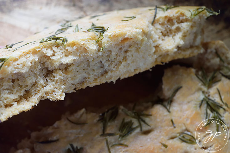 A closeup of a broken piece of Whole Wheat Focaccia Bread to show the inside.