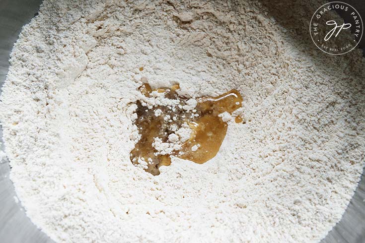 Oil in flour and salt in a mixing bowl.