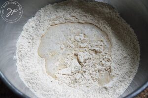 All the dough ingredients for Whole Wheat Focaccia Bread in a large mixing bowl.