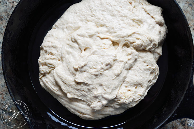 The raw Whole Wheat Focaccia Bread dough in a greased skillet.