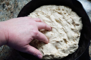 Stippling the dough with fingers.