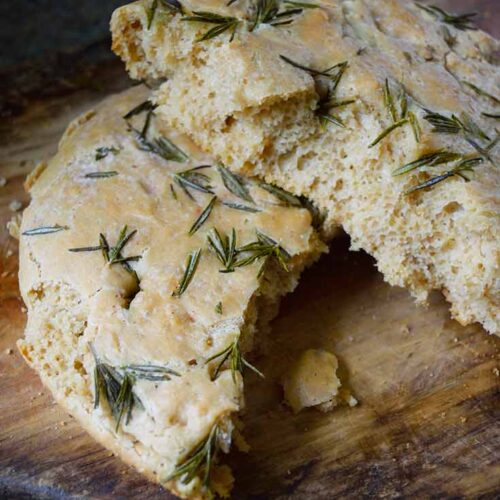 Two halves, one laying partially on the other, of Whole Wheat Focaccia Bread.