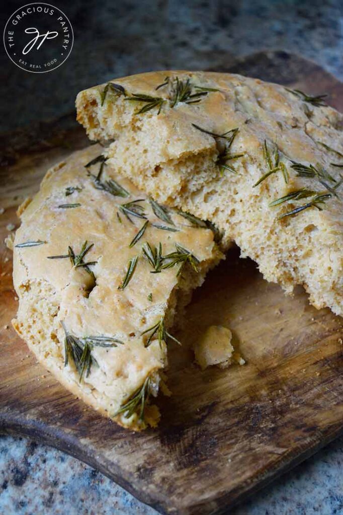 Two halves, one laying partially on the other, of Whole Wheat Focaccia Bread.