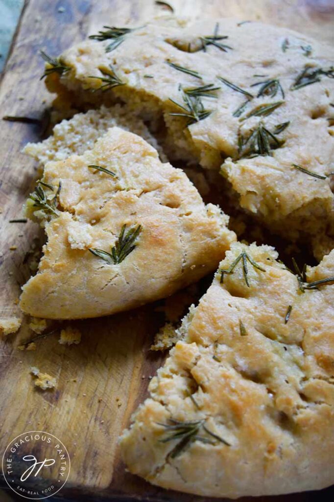 A side view of Whole Wheat Focaccia Bread in three pieces on a cutting board.