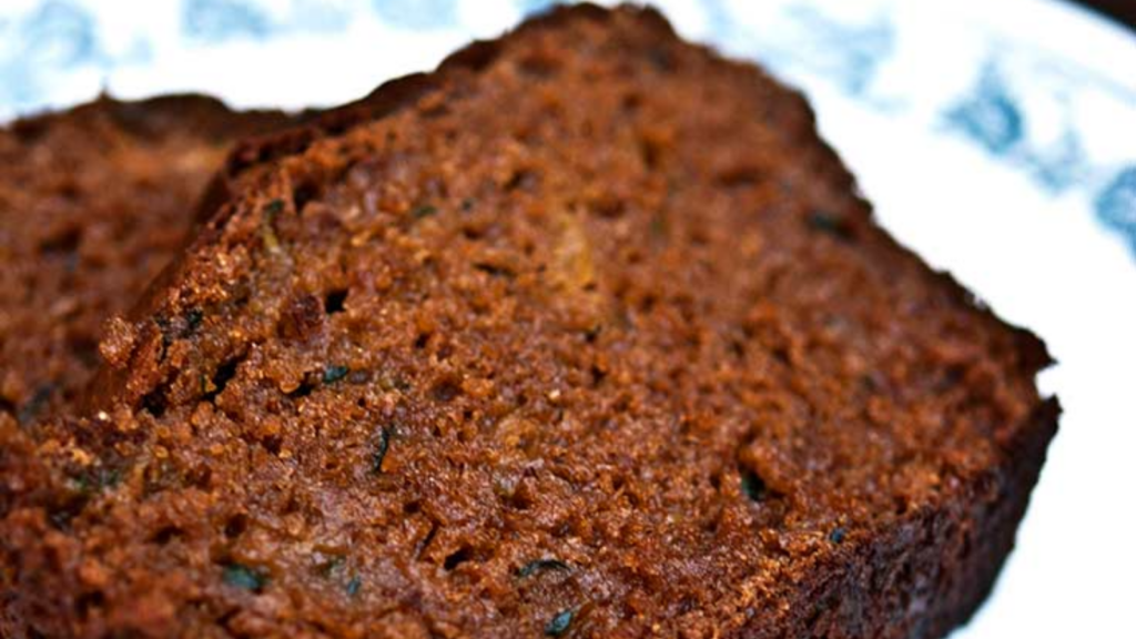 Two slices of zucchini bread on a white plate.