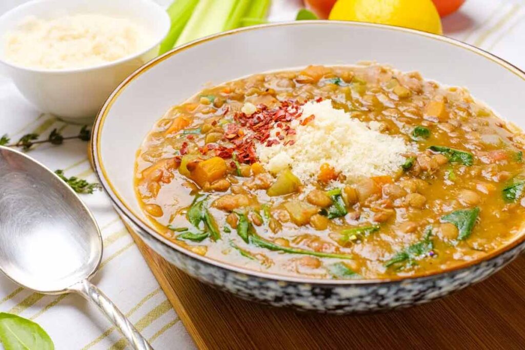 A bowl of lentil soup sits on a table.