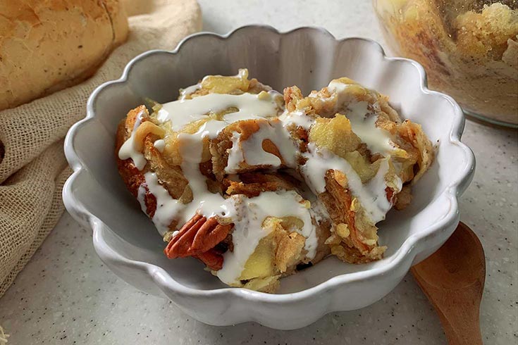 A fluted, white bowl filled with a serving of Instant Pot French Toast.