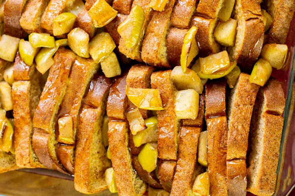 A closeup of apple french toast casserole in a baking dish.