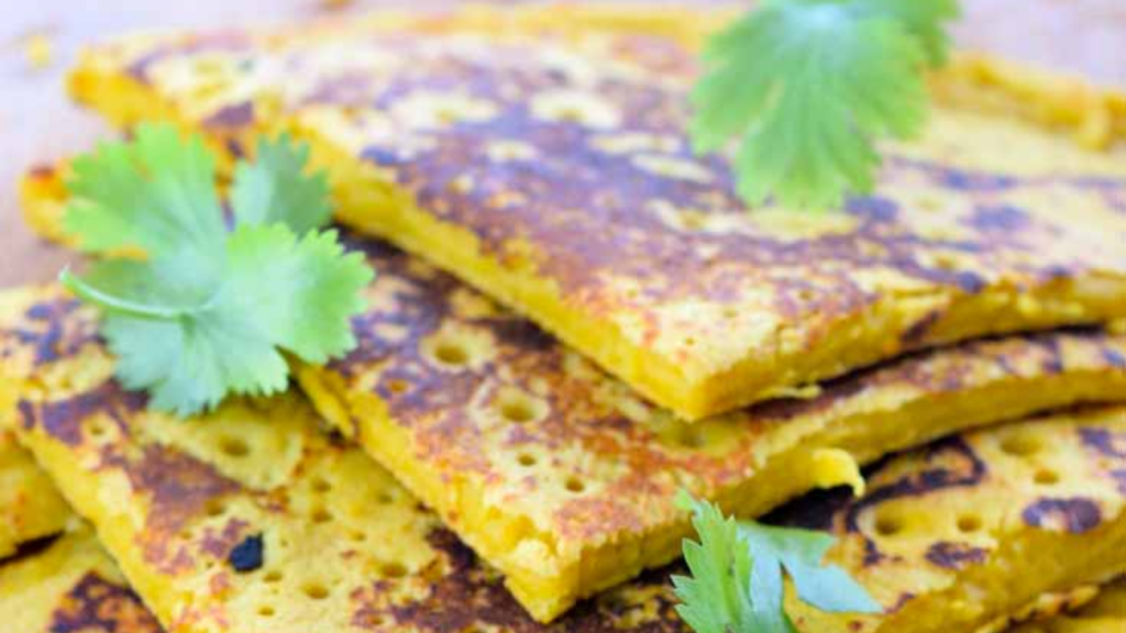 A pile of cut chickpea flour flatbread.