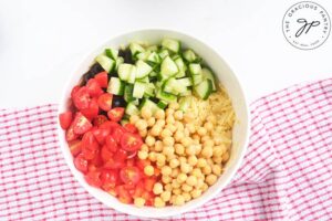 Chickpea Orzo Salad Recipe ingredients in a white mixing bowl.