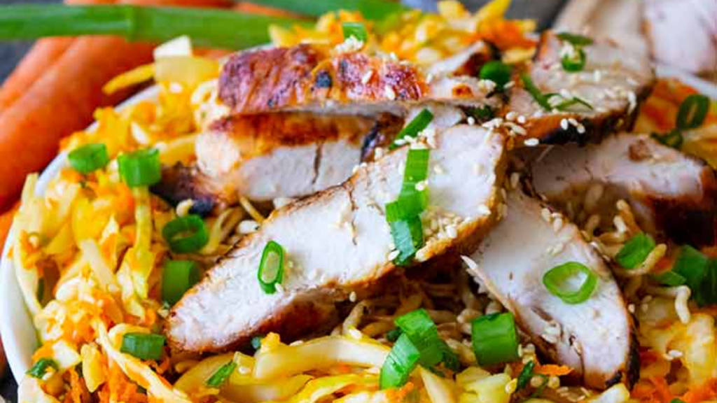 Closeup of a Chinese chicken salad in a white bowl.