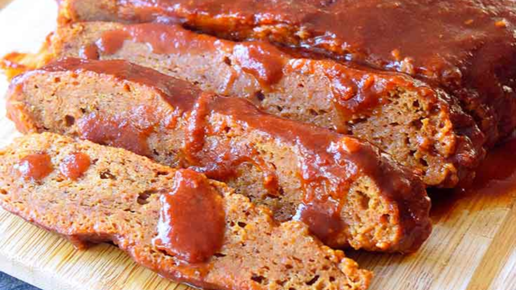 An up close shote of a seitan brisket sliced with bbq sauce drizzled over the top.