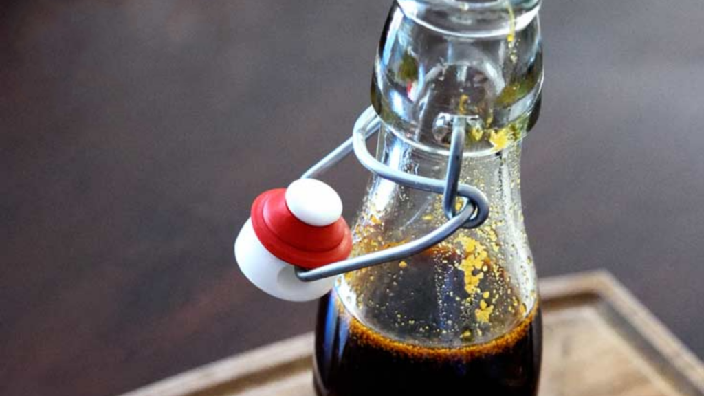 A glass bottle filled with teriyaki sauce.
