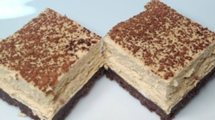 Two keto coffee cheesecake bars on a white background.