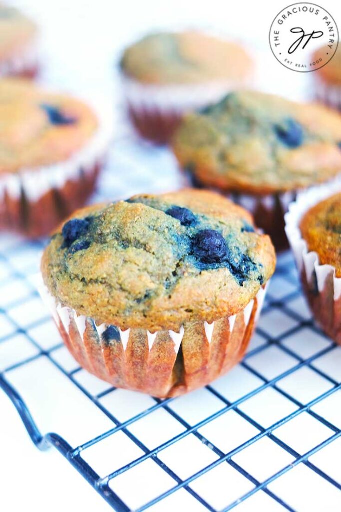 Blueberry corn muffins cooling on a cooling rack.