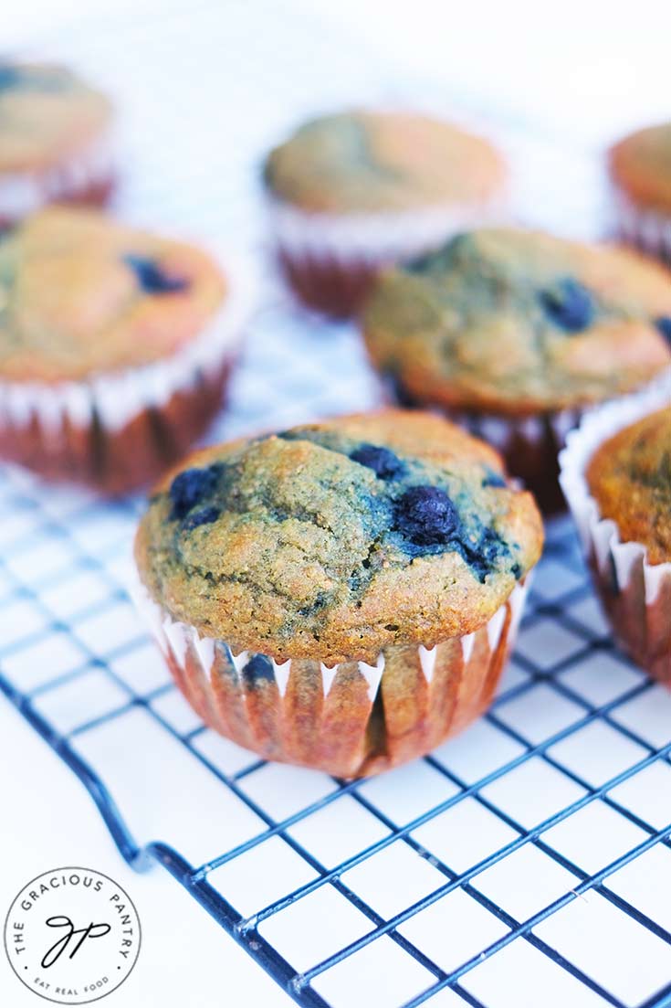 Blueberry corn muffins cooling on a cooling rack.