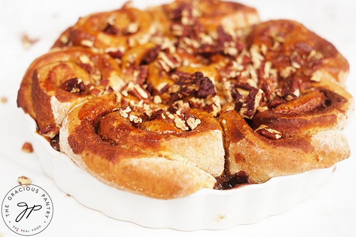 A side view of Homemade Cinnamon Rolls in a white baking pan.