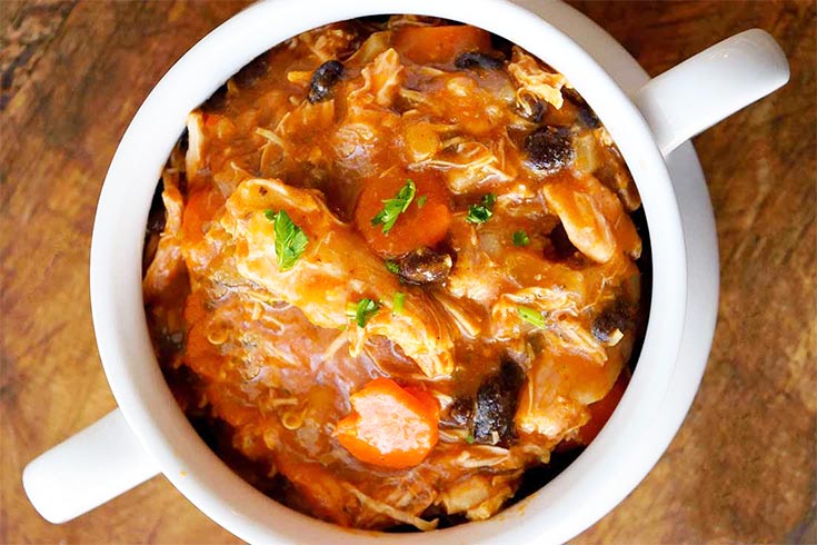 An overhead view of a white crock filled with Instant Pot Chicken Stew.