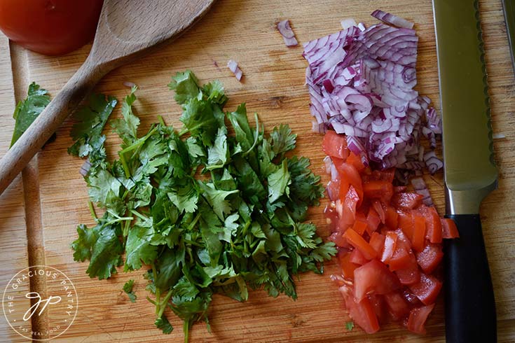 Chopped fresh onions, tomatoes and cilantro for topping nacho fries.