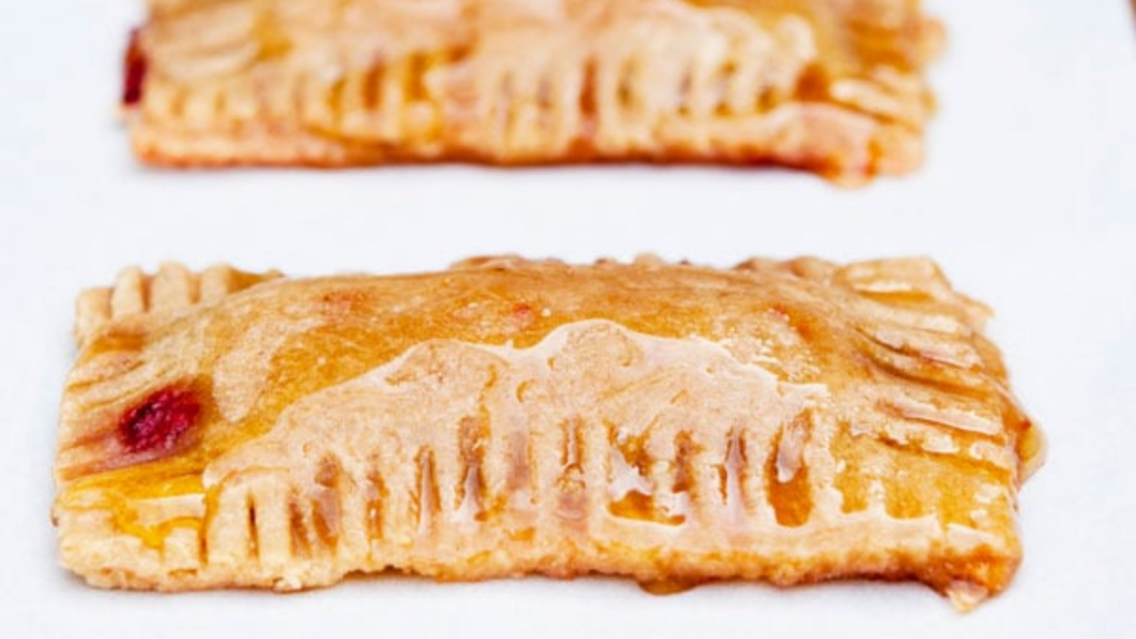 A homemade pop tart on a white plate.