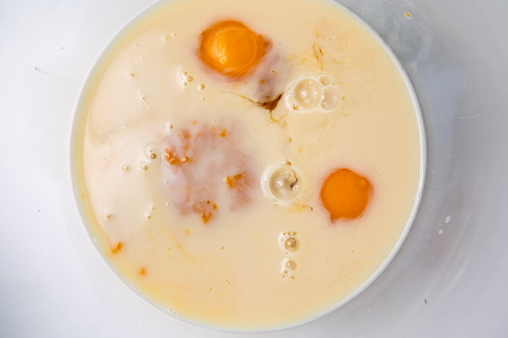 Eggs and milk in a large mixing bowl.