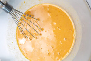 Wet ingredients mixed in a large mixing bowl.