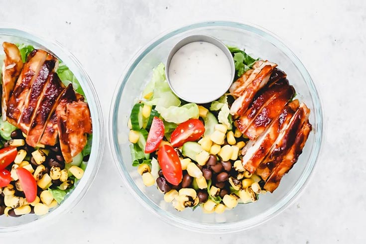 An overhead view of two bowls filled with southwestern salads.
