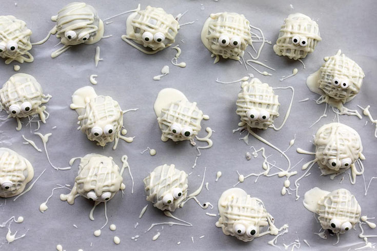 Chocolate truffle mummies cooling on parchment paper.