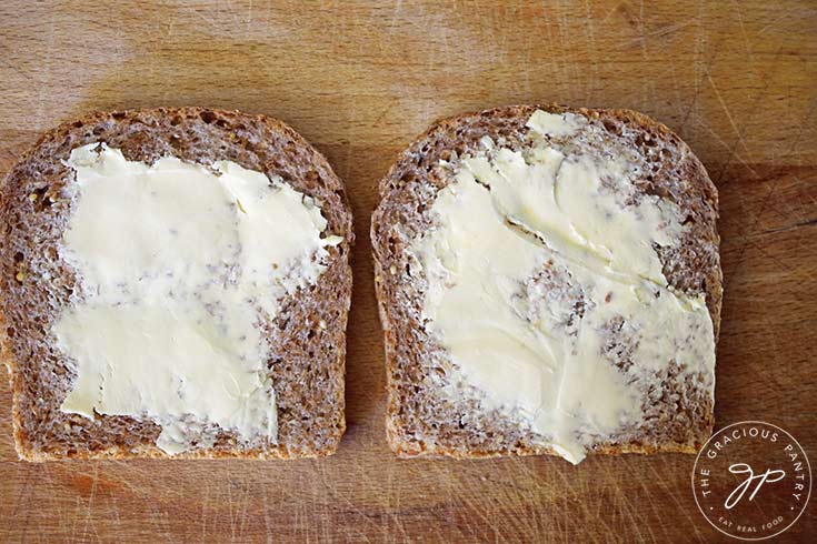Butter spread on two slices of bread.