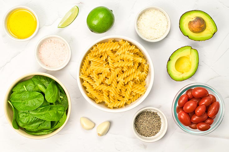 Recipe ingredients in individual bowls on a white surface.