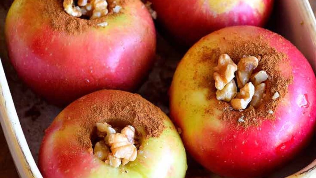 Unbaked apples in a casserole dish, ready to go into the oven.