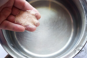 Adding salt to pasta water.