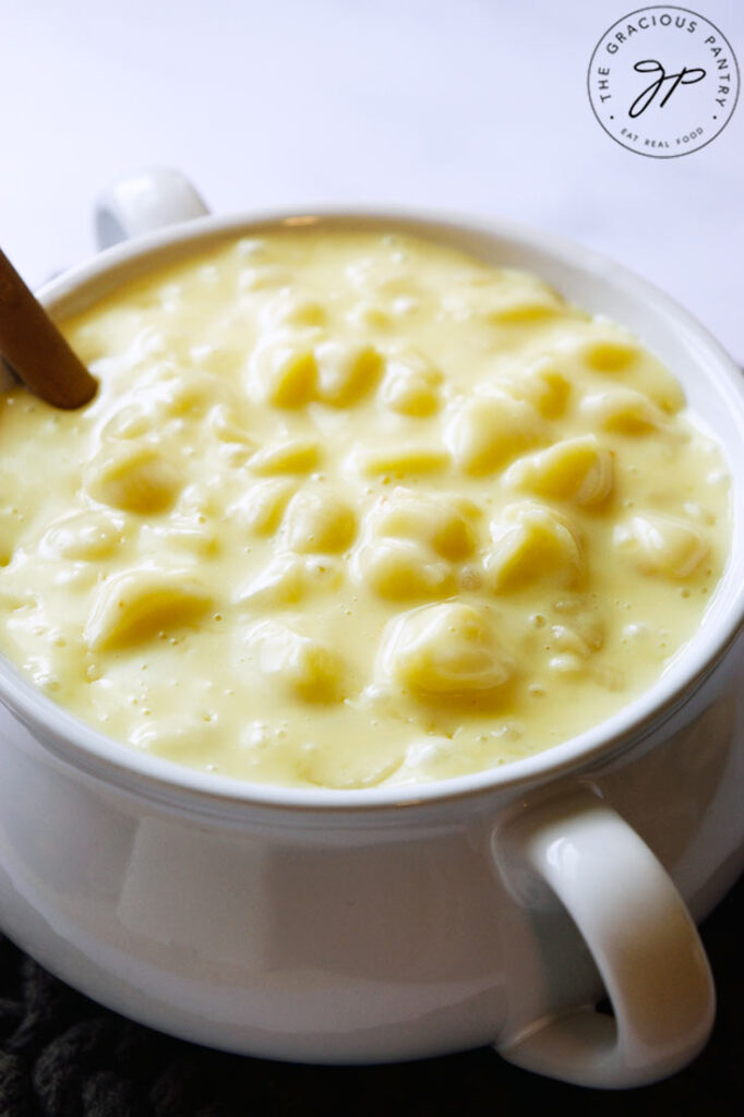 A white crock filled with Homemade Mac and Cheese.