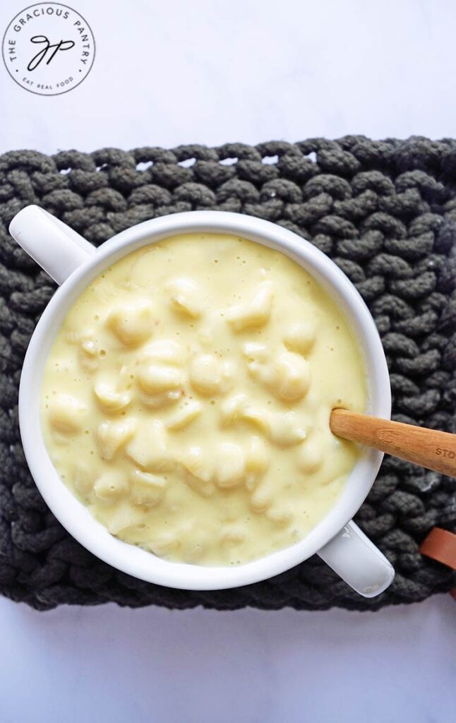An overhead view of a white crock filled with homemade mac and cheese.