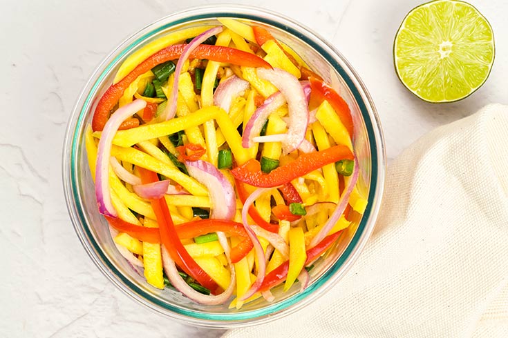 Mixed mango salad in a mixing bowl.