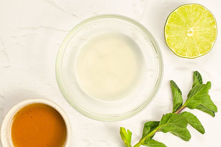 Mango Salad dressing ingredients in individual bowls on a white background.