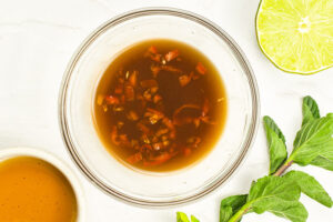 Mango salad dressing mixed in a glass bowl.