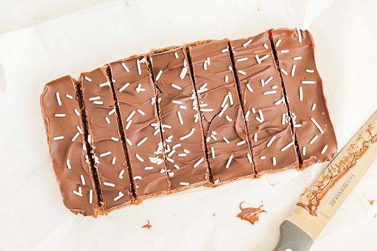 No Bake Pumpkin Protein Bars cut into strips on a piece of parchment.