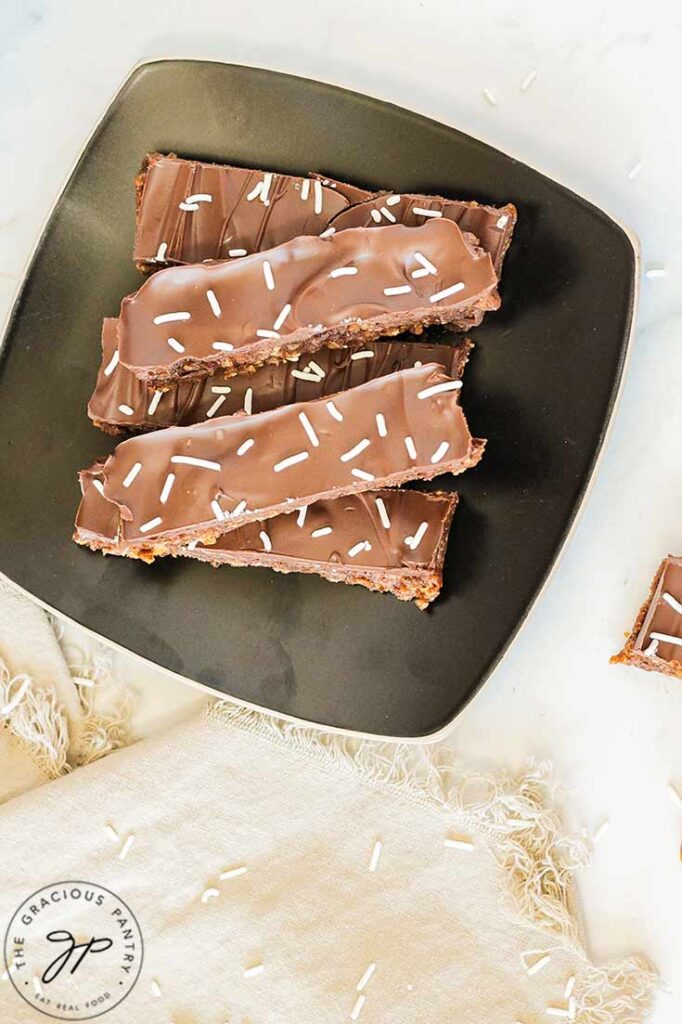 An overhead view of a black, square plate holding a batch of No Bake Pumpkin Protein Bars.