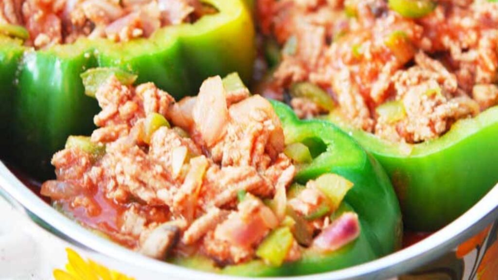 A pot filled with stuffed bell peppers.