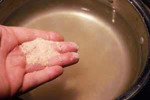 Adding salt to pasta water.