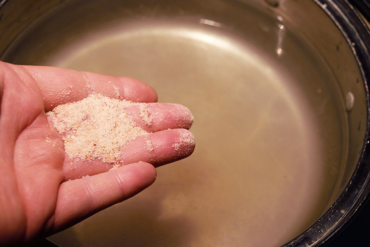 Adding salt to pasta water.