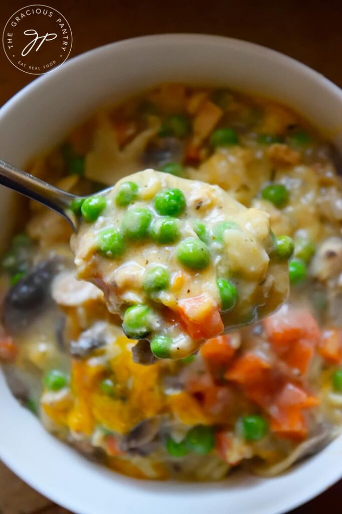 A spoon showing a scoop of Tuna Noodle Casserole on it.