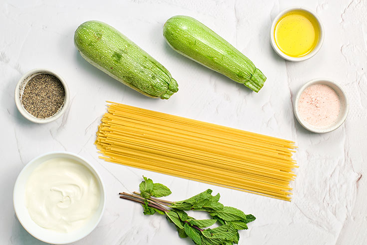 Individual ingredients for this Zucchini Pasta Recipe on a white background.