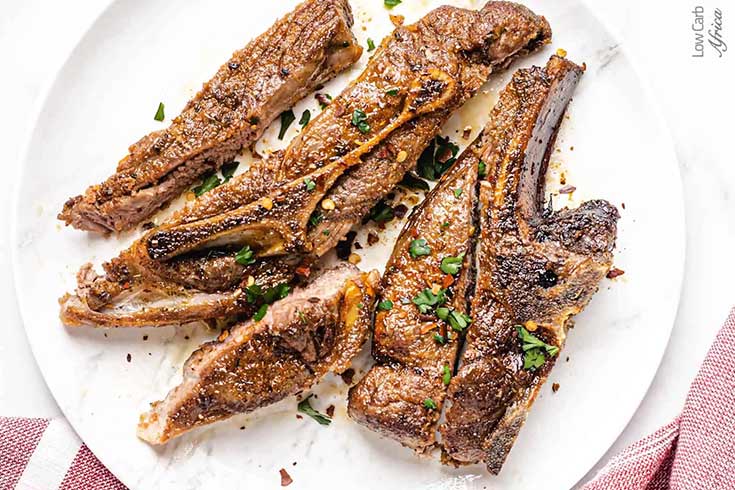 A white platter filled with air fryer lamb chops.