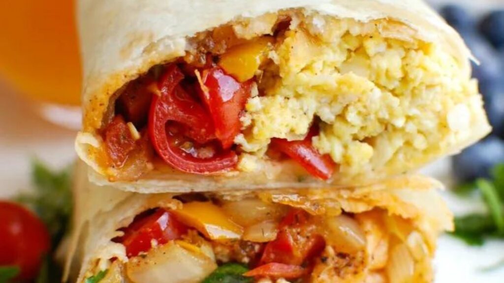 A closeup of a stacked vegetarian breakfast burrito.